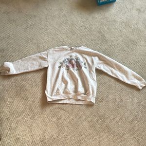 The brand is Gildan it’s size medium light grey feminine crew neck
